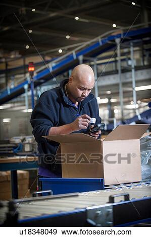 Male warehouse worker using barcode scanner View Large Photo Image Stock Photo - Male warehouse worker using barcode scanner. Fotosearch