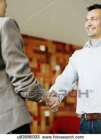 Man and woman shaking hands View Large Photo Image Stock Image - Man and woman shaking hands. Fotosearch
