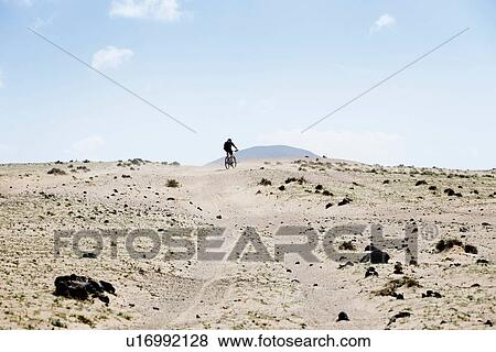 Man mountain biking, Lanzarote View Large Photo Image Stock Photo - Man mountain biking, Lanzarote. Fotosearch