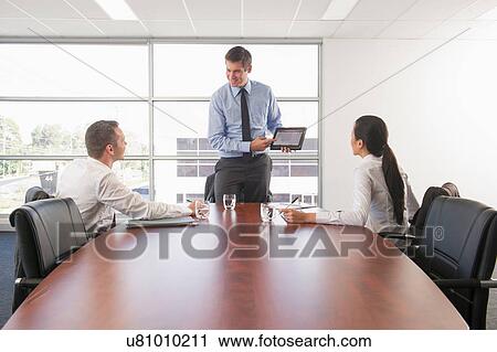 Manager and colleagues in office meeting View Large Photo Image Stock Image - Manager and colleagues in office meeting. Fotosearch