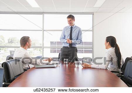 Manager and colleagues in office meeting View Large Photo Image Stock Photo - Manager and colleagues in office meeting. Fotosearch