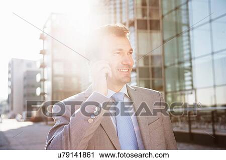Mature businessman on cellphone in city View Large Photo Image Stock Image - Mature businessman on cellphone in city. Fotosearch