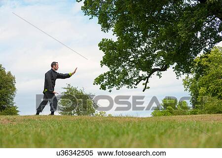 Mature man performing Tai Chi in countryside View Large Photo Image Stock Photography - Mature man performing Tai Chi in countryside. Fotosearch