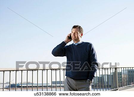 Mature man using cellphone outdoors View Large Photo Image Stock Photograph - Mature man using cellphone outdoors. Fotosearch
