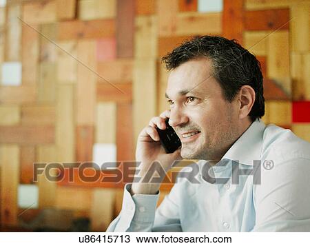 Mature man using cellphone, smiling View Large Photo Image Stock Image - Mature man using cellphone, smiling. Fotosearch