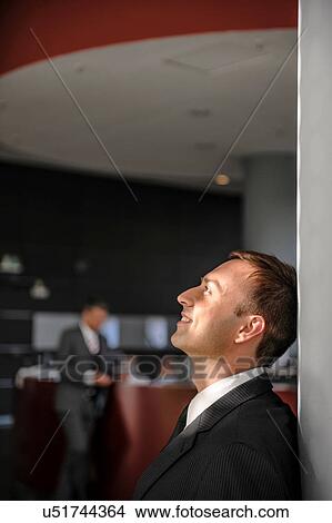 Mid adult businessman looking upwards View Large Photo Image Picture - Mid adult businessman looking upwards. Fotosearch