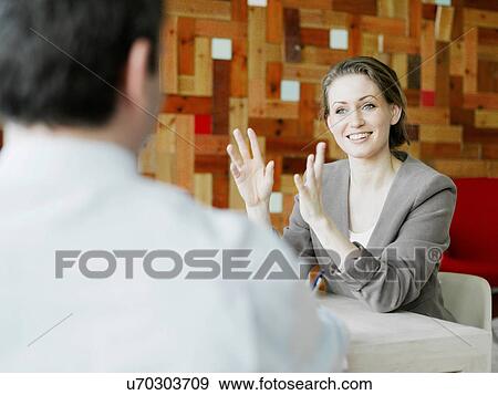 Mid adult businesswoman explaining in meeting View Large Photo Image Stock Photo - Mid adult businesswoman explaining in meeting. Fotosearch