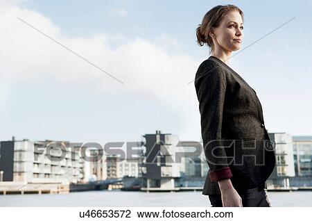 Mid adult businesswoman in city, looking away View Large Photo Image Stock Image - Mid adult businesswoman in city, looking away. Fotosearch