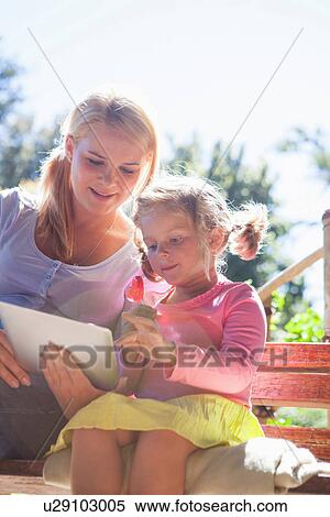 Mother and daughter using laptop in garden View Large Photo Image Stock Photography - Mother and daughter using laptop in garden. Fotosearch