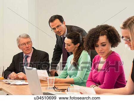 Stock Photo - Office colleagues in meeting. Fotosearch