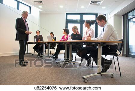 Office colleagues meeting in conference room View Large Photo Image Stock Photograph - Office colleagues meeting in conference room. Fotosearch
