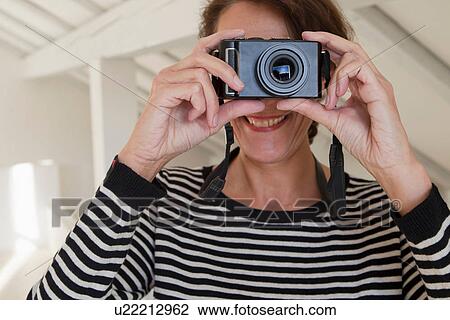Stock Image - Personal perspective of woman taking photograph. Fotosearch
