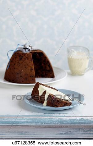 Stock Photography - Plum pudding with cream. Fotosearch