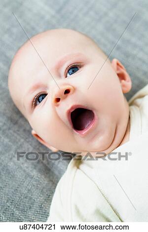 Stock Image - Portrait of baby boy yawning. Fotosearch