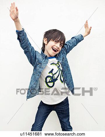 Stock Image - Portrait of boy with arms out against white background. Fotosearch