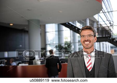 Portrait of businessman in reception area View Large Photo Image Stock Photo - Portrait of businessman in reception area. Fotosearch