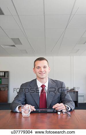 Portrait of businessman looking at camera View Large Photo Image Picture - Portrait of businessman looking at camera. Fotosearch