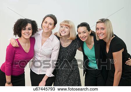 Portrait of female office workers with arms around each other View Large Photo Image Stock Image - Portrait of female office workers with arms around each other. Fotosearch
