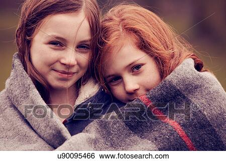 Portrait of girls wrapped in a blanket outdoors View Large Photo Image Stock Photograph - Portrait of girls wrapped in a blanket outdoors. Fotosearch