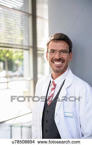 Portrait of mature doctor smiling View Large Photo Image Picture - Portrait of mature doctor smiling. Fotosearch