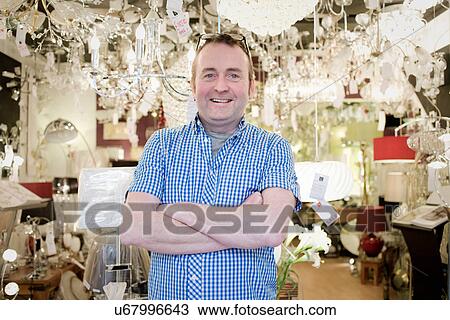Portrait of mature owner of light store, smiling View Large Photo Image Stock Image - Portrait of mature owner of light store, smiling. Fotosearch