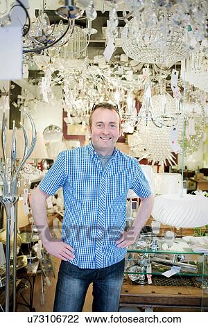 Portrait of mature owner of light store, smiling View Large Photo Image Stock Image - Portrait of mature owner of light store, smiling. Fotosearch