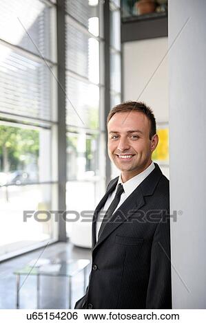 Portrait of mid adult businessman in office View Large Photo Image Stock Photograph - Portrait of mid adult businessman in office. Fotosearch