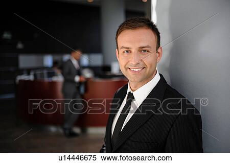Stock Photography - Portrait of mid adult businessman in office. Fotosearch