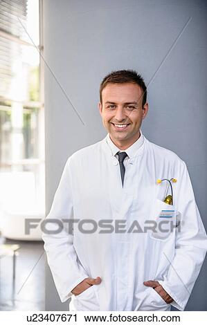 Stock Image - Portrait of mid adult doctor smiling. Fotosearch