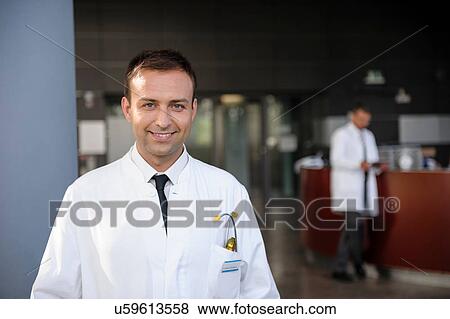 Portrait of mid adult doctor smiling View Large Photo Image Stock Photo - Portrait of mid adult doctor smiling. Fotosearch