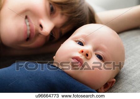 Portrait of mother with baby son lying down, close up View Large Photo Image Stock Image - Portrait of mother with baby son lying down, close up. Fotosearch
