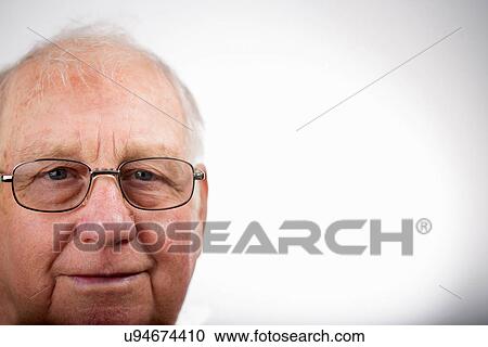 Stock Image - Portrait of senior man wearing glasses, studio shot. Fotosearch