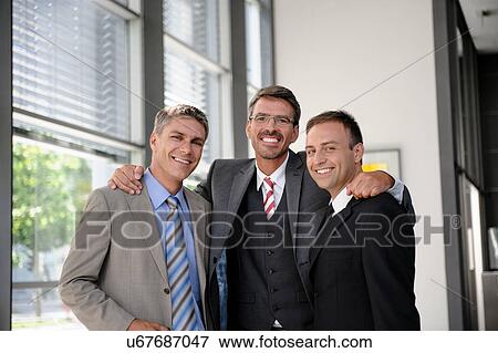 Stock Photo - Portrait of three smiling businessmen. Fotosearch