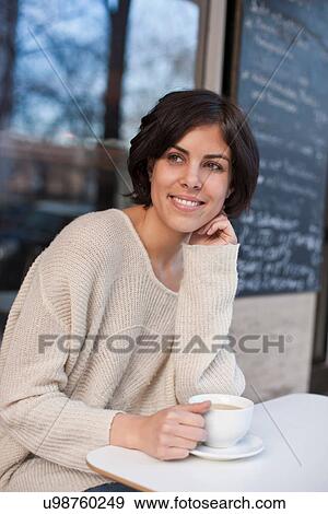 Portrait of woman outside cafe with coffee View Large Photo Image Stock Photo - Portrait of woman outside cafe with coffee. Fotosearch