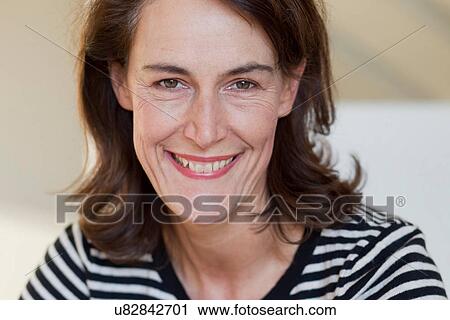 Portrait of woman wearing striped top View Large Photo Image Stock Image - Portrait of woman wearing striped top. Fotosearch