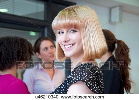 Portrait of woman with blonde bob and colleagues in background View Large Photo Image Stock Image - Portrait of woman with blonde bob and colleagues in background. Fotosearch