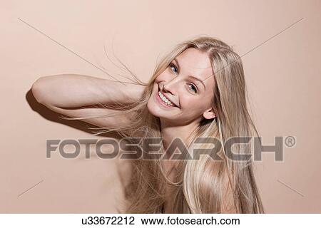 Stock Image - Portrait of young blonde woman, close up. Fotosearch