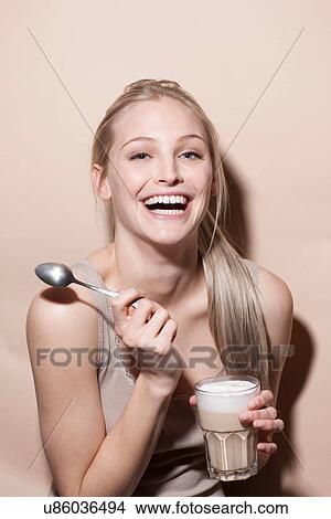 Portrait of young blonde woman holding coffee View Large Photo Image Picture - Portrait of young blonde woman holding coffee. Fotosearch