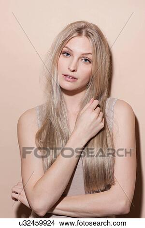Portrait of young blonde woman, studio shot View Large Photo Image Picture - Portrait of young blonde woman, studio shot. Fotosearch