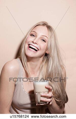Picture - Portrait of young blonde woman with milk moustache. Fotosearch