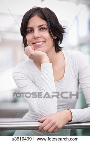 Portrait of young female leaning on handrail View Large Photo Image Stock Image - Portrait of young female leaning on handrail. Fotosearch