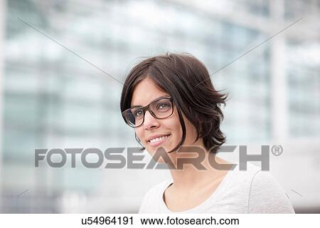 Stock Image - Portrait of young female wearing spectacles. Fotosearch