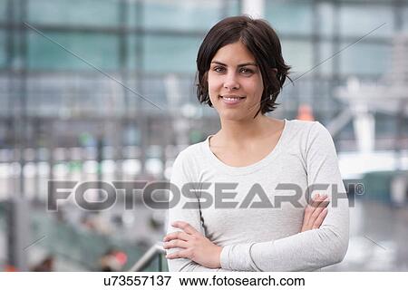 Portrait of young female with arms folded View Large Photo Image Stock Photo - Portrait of young female with arms folded. Fotosearch