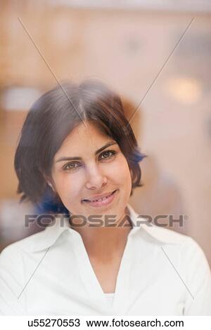 Portrait of young woman looking out of window View Large Photo Image Stock Image - Portrait of young woman looking out of window. Fotosearch