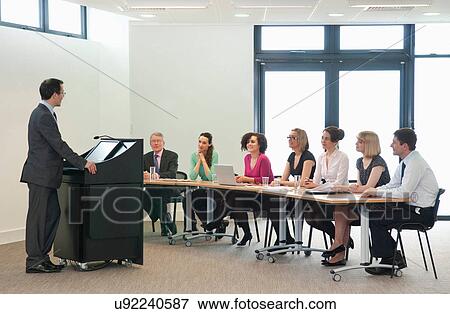 Presenter speaking to group of colleagues View Large Photo Image Stock Photo - Presenter speaking to group of colleagues. Fotosearch