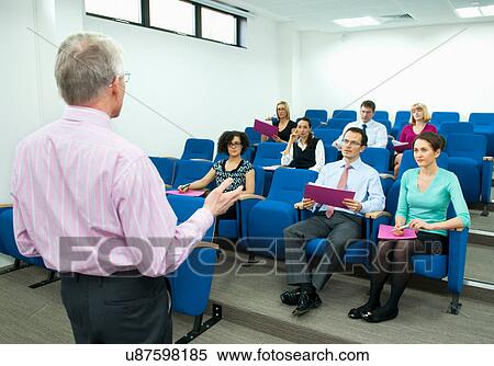 Presenter speaking to group of colleagues View Large Photo Image Stock Photography - Presenter speaking to group of colleagues. Fotosearch