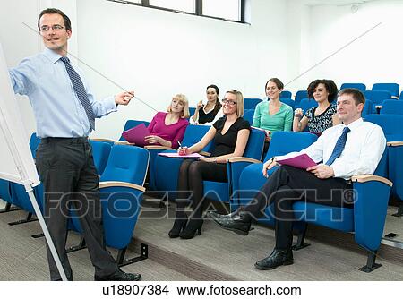 Picture - Presenter talking to group of colleagues. Fotosearch