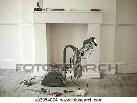 Sander and tools by fireplace of new home View Large Photo Image Picture - Sander and tools by fireplace of new home. Fotosearch