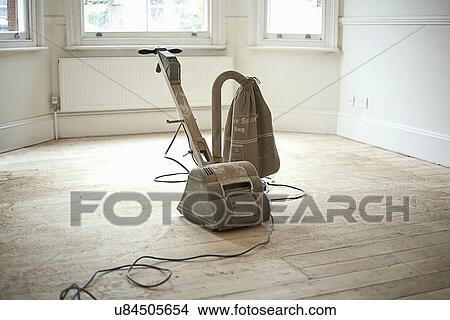 Picture - Sander on wooden floorboards of new home. Fotosearch