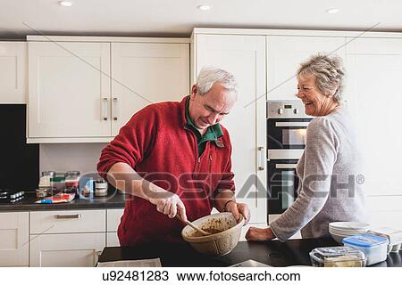 Senior couple baking in kitchen View Large Photo Image Stock Image - Senior couple baking in kitchen. Fotosearch
